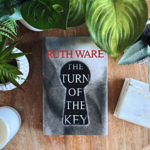 The Turn of the Key by Ruth Ware is a tense, gothic, psychological thriller with a grey cover and a black key on it