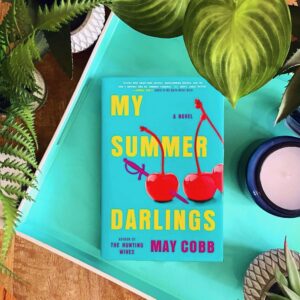 My Summer Darlings is a twisted, dark psychological suspense novel by May Cobb with a turquoise cover featuring bright red cherries
