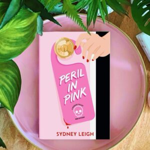 Peril in Pink is the first in a debut cozy mystery series by Sydney Leigh, featuring two friends who open a bed and breakfast that is decked out in pink