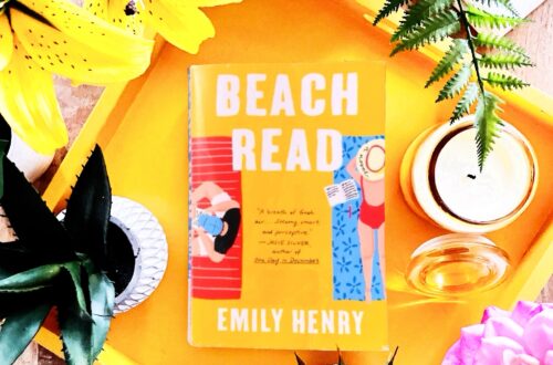 Beach Read is a contemporary fiction book by Emily Henry that features a golden yellow cover with a man and a woman laying on beach towels side by side